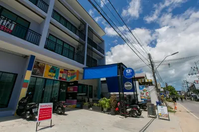 a gas station with motorcycles parked in front of a building at Wow Academy & Stay Soi Tai-Aed 2B in Ban Suan