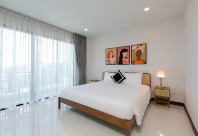 a bedroom with a bed and a large window at Wow Academy & Stay Soi Tai-Aed 3B in Ban Suan