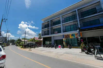 a building with motorcycles parked on the side of a street at Wow Academy & Stay Soi Tai-Aed 3B in Ban Suan