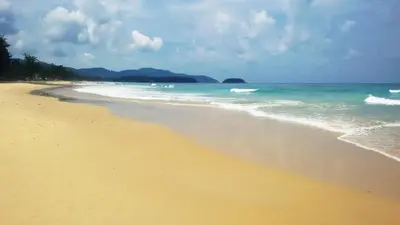 a sandy beach with the ocean and the sky at Karon Suite Apartment in Karon Beach
