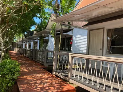 a porch of a house with a wooden railing at Isle Beach Resort Krabi-SHA in Klong Muang Beach