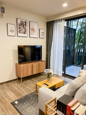 a living room with a couch and a flat screen tv at The Deck condominium Patong beach in Patong Beach