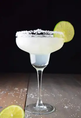 a margarita with a lime on a wooden table at Micky Monkey Beach Hotel Phuket Maikhao Thailand in Mai Khao Beach
