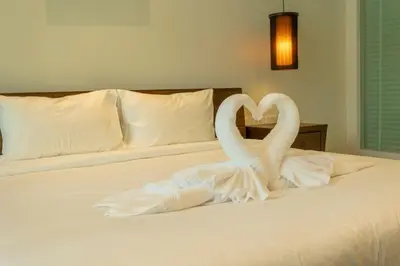 two white swans making a heart on a bed at Oxygen 3BR Walk to Shops, Bars, Private Pool v113 in Rawai Beach
