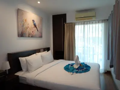 a bedroom with a bed with a stuffed bird on it at Private apartment at Phuket Villa Condo in Patong Beach