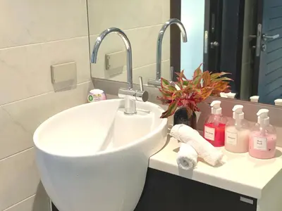 a bathroom with a white sink and a mirror at EMERALD TERRACE CONDO 52-FAMILY 1 Bedroom POOL VIEW in Patong Beach