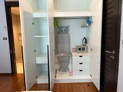 a room with a closet with a bed and a microwave at EMERALD TERRACE CONDO 52-FAMILY 1 Bedroom POOL VIEW in Patong Beach