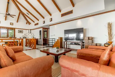 a living room with orange couches and a table at Villa Suriya B2 in Patong Beach