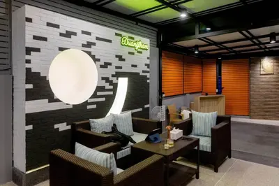 a lobby with couches and a sign on a brick wall at Pool Villa No 10 by Duangtham in Ban Khlong Haeng