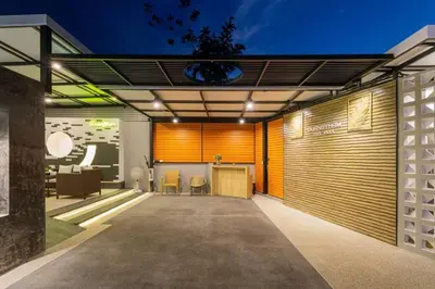an open garage with a table and chairs at Pool Villa No 10 by Duangtham in Ban Khlong Haeng