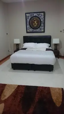 a bedroom with a large bed with two lamps at Villa Happy home in Rawai Beach