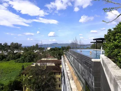 a view of the water from the balcony of a building at Cozy Surin apartment at 6 Avenue by Lofty in Surin Beach