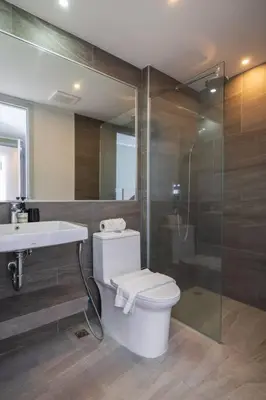 a bathroom with a toilet and a sink and a shower at Modern Condo near the Beach - NV531 in Phuket Town