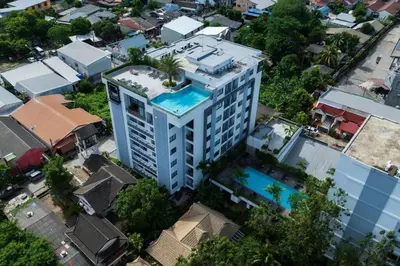 an overhead view of a tall building with a swimming pool at Modern Condo near the Beach - NV531 in Phuket Town