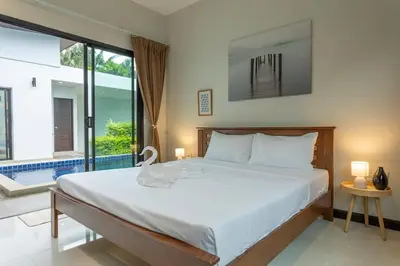 a bedroom with a large bed and a pool at 2 Beds large pool night market Soi Namjai v122 in Rawai Beach