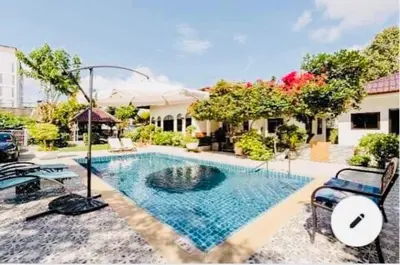 a swimming pool in the middle of a house at Studio Room with private kitchen and Bathroom in Ban Phlu Yai