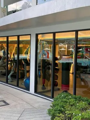a store front window of a building with reflections in it at Spacious apartment 600m from the beach in Rawai Beach