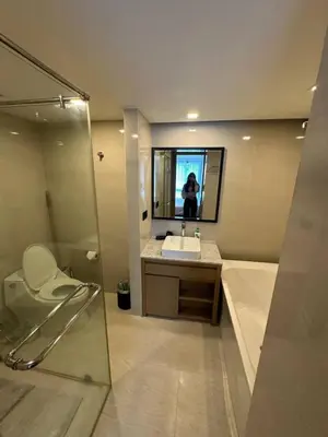 a bathroom with a toilet and a sink and a mirror at Spacious apartment 600m from the beach in Rawai Beach