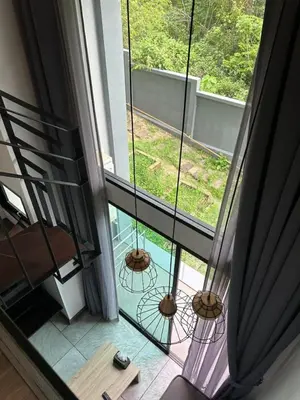 a room with a view of a balcony at Utopia Naiharn Beach B16 in Rawai Beach