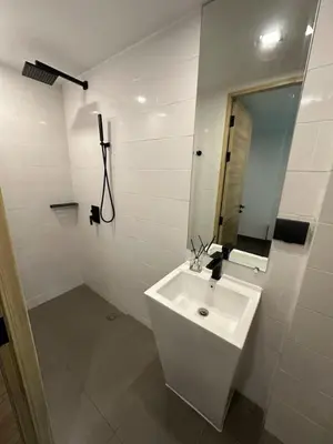 a white bathroom with a sink and a mirror at Utopia Naiharn Beach B16 in Rawai Beach