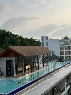 a swimming pool on the roof of a building at Palmyrah Surin sea view in Surin Beach