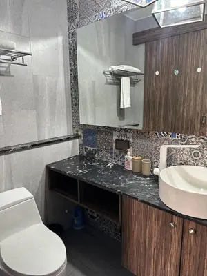 a bathroom with a toilet and a sink at Palmyrah Surin sea view in Surin Beach