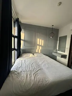 a bedroom with a large bed with a white comforter at Palmyrah Surin sea view in Surin Beach