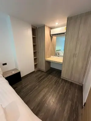a small room with a bed and a mirror at Duplex studio on Naiharn Beach B21 in Rawai Beach