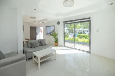 a living room with a couch and a table at The coconut nanai resort in Patong Beach
