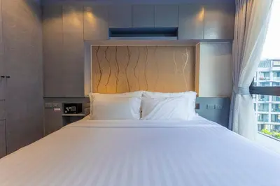 a large bed in a room with a window at C141 Fully Loaded Best Facilities Nicest Apartment in Kamala Beach