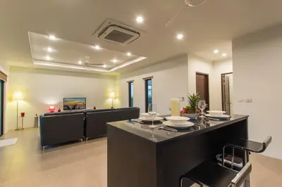 a dining room with a table and chairs in a room at Tropical 3BR Pool Villa Nga Chang NC10, Gated Residence, 10 min Drive to Nai Harn Beach in Rawai Beach