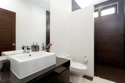 a bathroom with a white sink and a toilet at Tropical 3BR Pool Villa Nga Chang NC10, Gated Residence, 10 min Drive to Nai Harn Beach in Rawai Beach