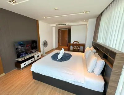 a bedroom with a bed and a television in it at Sea view apartment at Privilege by Lofty in Patong Beach