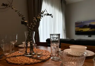 a dining room table with a vase with flowers in it at The Title Halo 1 Apartment 10 min to Nai Yang Beach in Nai Yang Beach