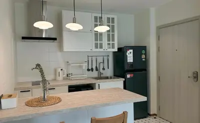 a kitchen with white cabinets and a green refrigerator at The Title Halo 1 Apartment 10 min to Nai Yang Beach in Nai Yang Beach