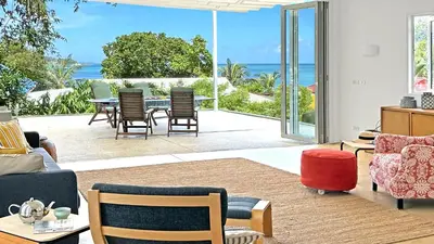 a living room with a view of the ocean at At the Beach Spacious 2-level Design Home for 2-5 and 1 infant, Ao Yon Beach Phuket in Ban Ao Makham