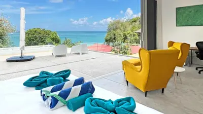 a living room with a view of the ocean at At the Beach Spacious 2-level Design Home for 2-5 and 1 infant, Ao Yon Beach Phuket in Ban Ao Makham