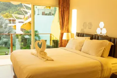 a bedroom with a bed with two swans on it at 12 minutes Patong Security Gym Sauna AP12 #V28 in Kamala Beach