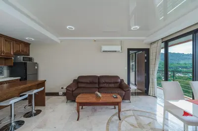 a living room with a couch and a table at Уютные апартаменты NBC Nai Harn in Rawai Beach