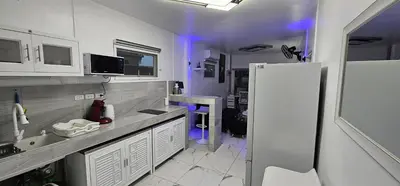 a kitchen with a sink and a white refrigerator at Prestige Pool Villa by Karon Homes in Karon Beach