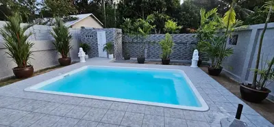 a swimming pool in a backyard with potted plants at Prestige Pool Villa by Karon Homes in Karon Beach
