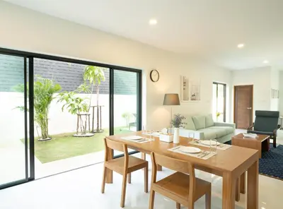 a dining room with a table and a living room at Krabi Private Pool Villa 1 by Belcarrra Spaces in Ban Khlong Haeng