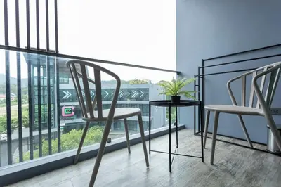 a pair of chairs and a table on a balcony at Nicest Condo in City gate Kamala 6km Patong #c118 in Kamala Beach