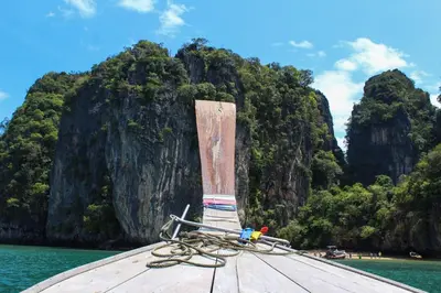 a boat with a rope sitting on a dock in the water at JK Studio, Koh Yao Noi in Ko Yao Noi