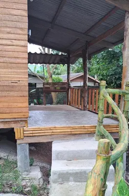 a wooden porch with a wooden bench on it at Big Hug Home - Sa med kaw in Ban Takhrai