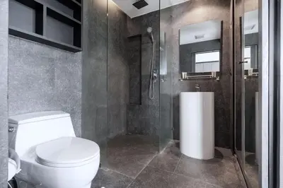 a bathroom with a toilet and a glass shower at Urban Suite CTG B702 in a Gated Tropics Kamala Residence with 3 Pools & Gym in Kamala Beach