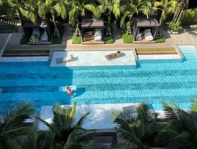 an overhead view of a swimming pool with two people in it at Luxury Suite of 70 Sqm in Rawai Beach in Ban Saiyuan (1)