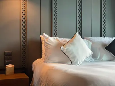 a bed with white sheets and pillows on it at Luxury Suite of 70 Sqm in Rawai Beach in Ban Saiyuan (1)