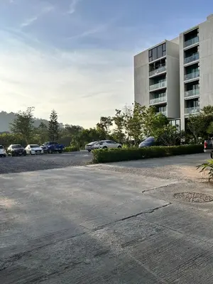 a parking lot with cars parked in front of a building at The Viva Patong Condo - 1Bdr - 35sqm Studio - Patong Hills in Patong Beach