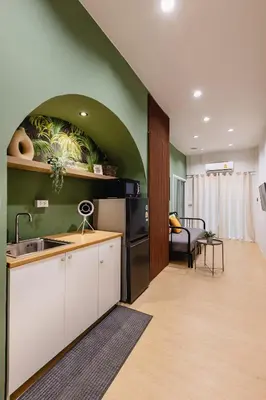 a kitchen with a sink and a living room at Patong Apartments Steps to Beach & Bangla Road Sleeps 6 in Patong Beach